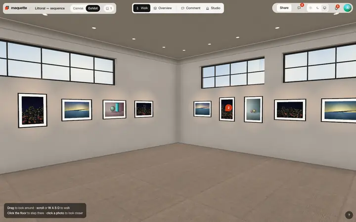 The exhibit: framed photographs along two plaster walls under clerestory windows, a concrete floor.